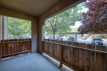 Corner Patio with sliding glass door to Living area - 4 foot fence - stucco walls and ceiling